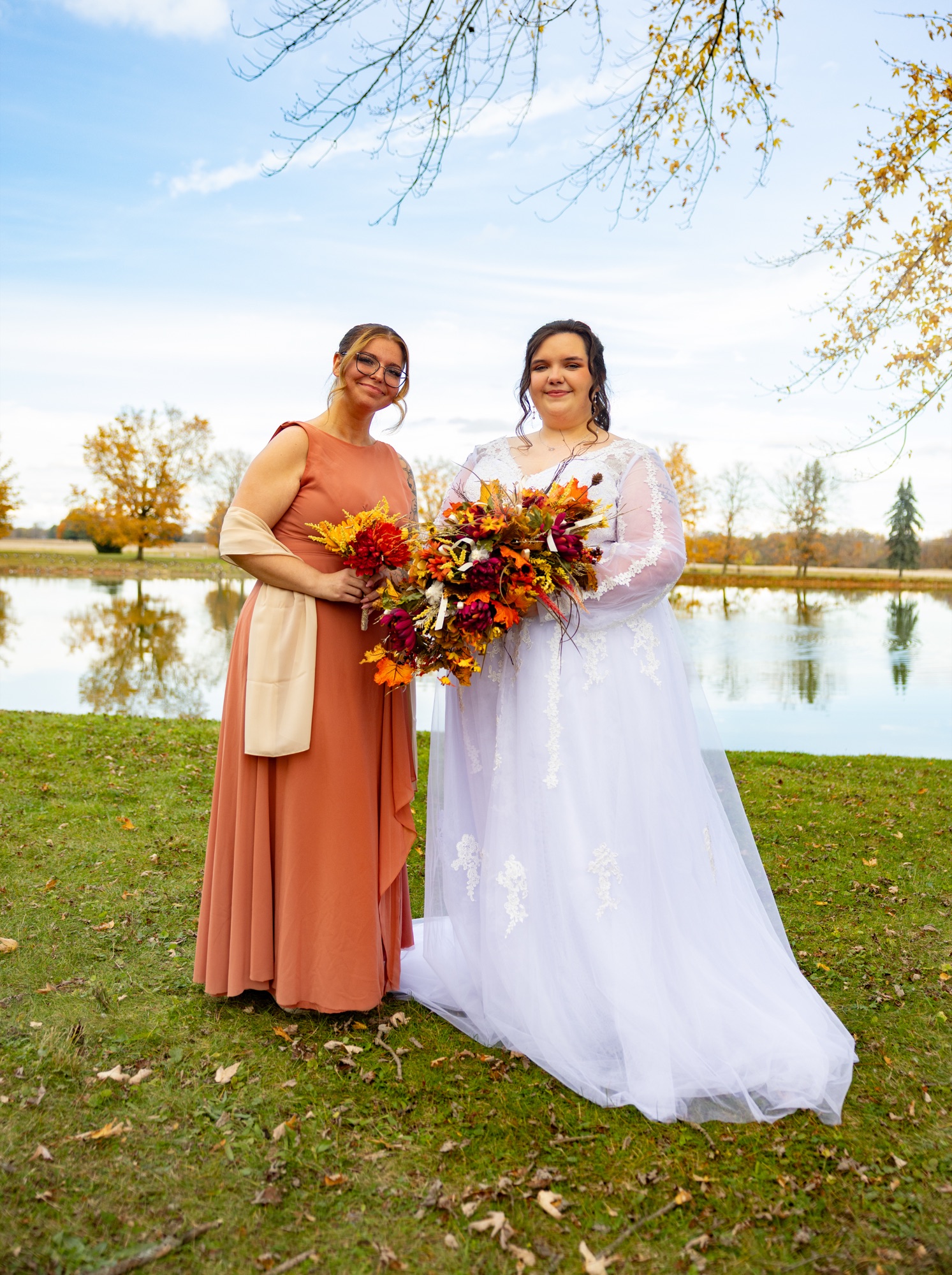 Bride and bridesmaid with autumn bouquets