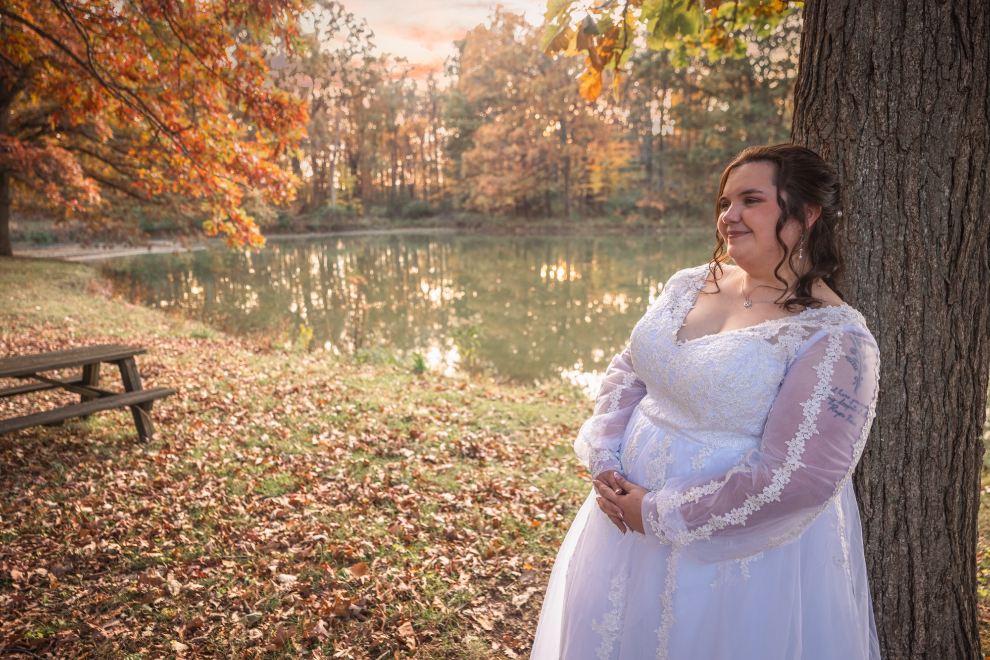 Bride beneath the autumn trees