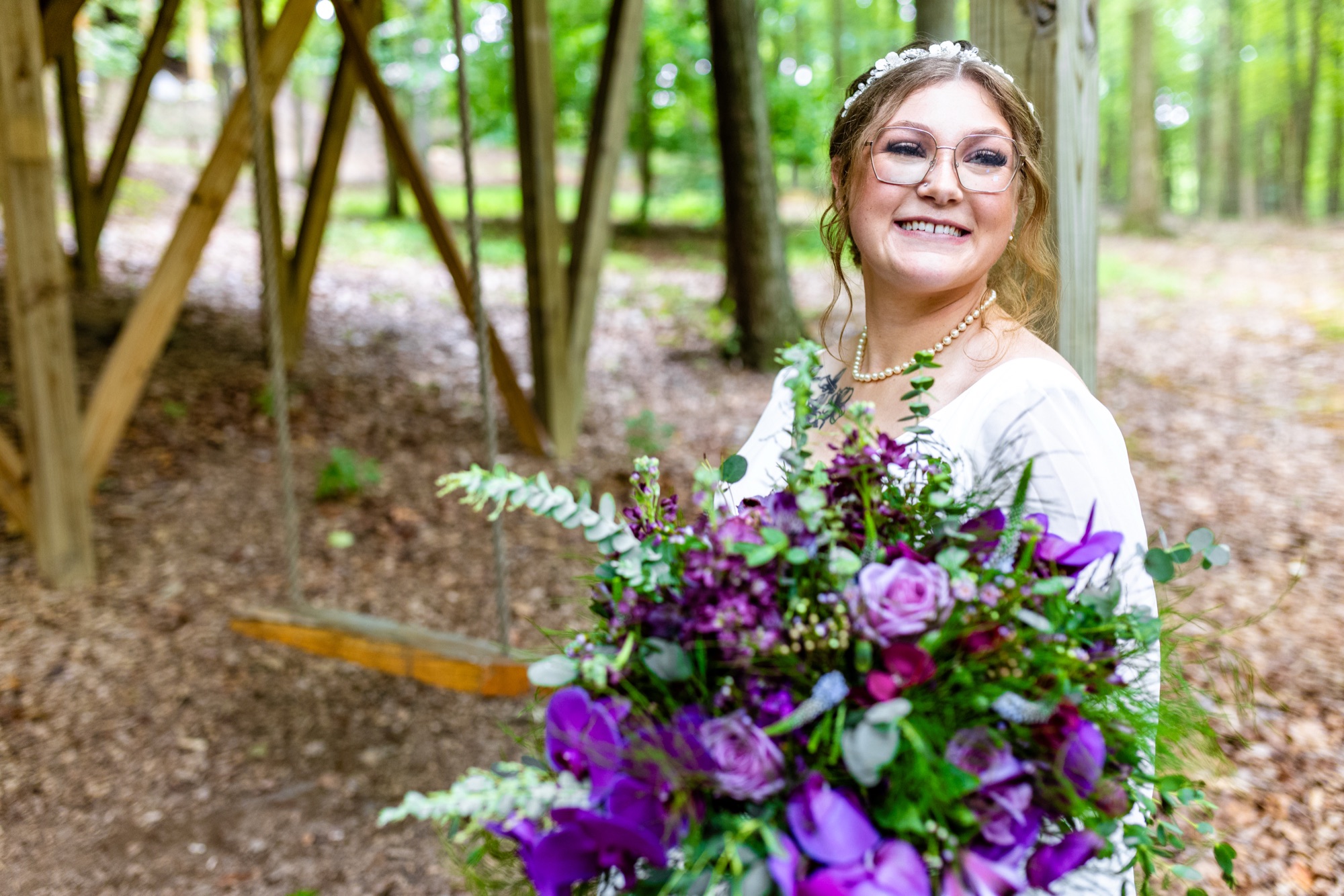 Bride with her bouquet in the woods